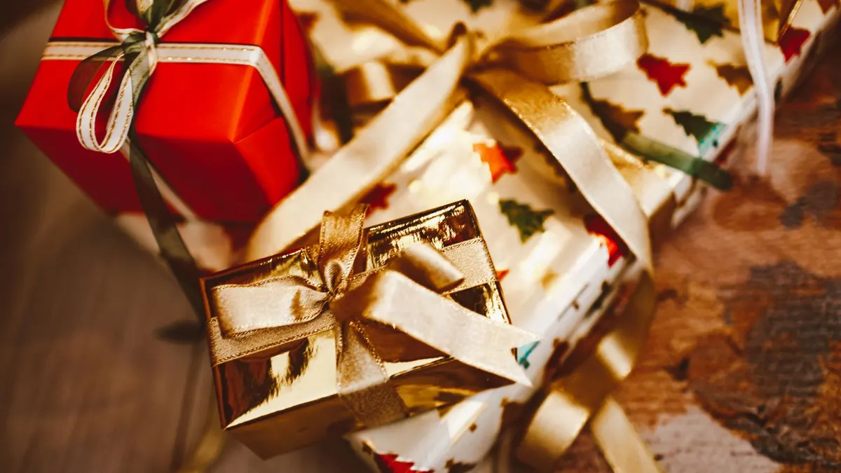 Wrapped Christmas gifts with ribbons and greenery