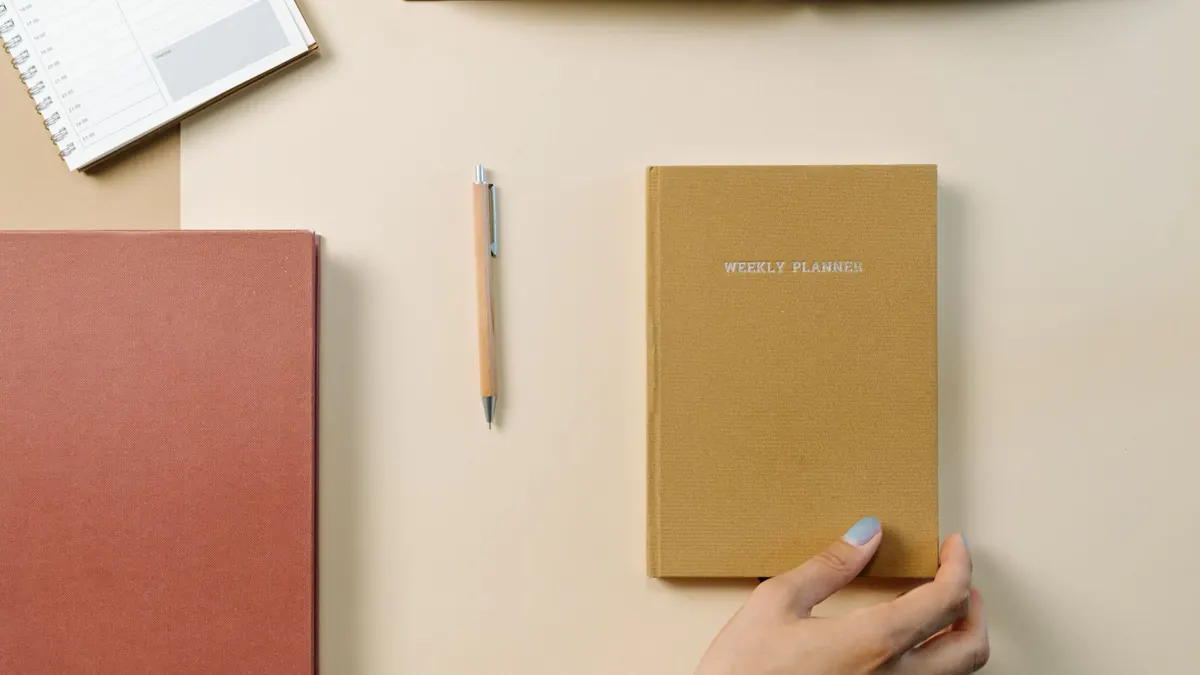 Weekly planners and pencils arranged on a light desk