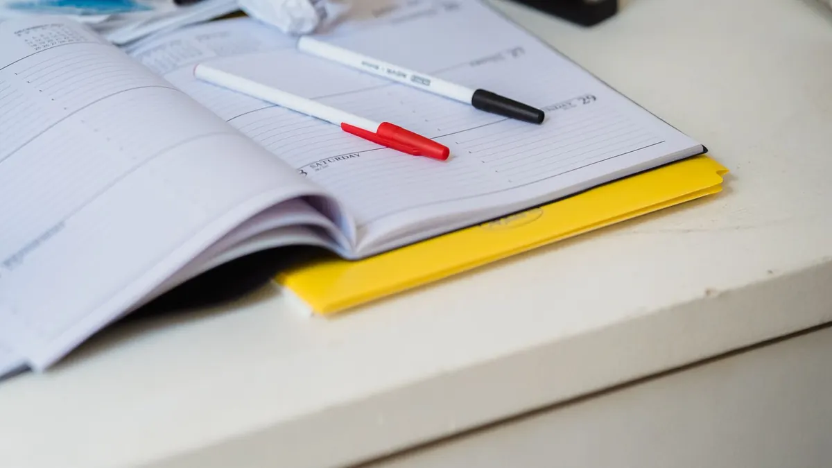Pens resting across an open weekly planner