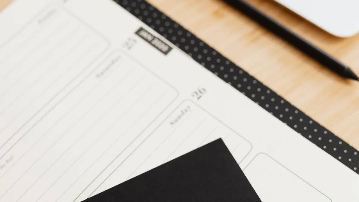Printed planner pages on a tidy wooden desk
